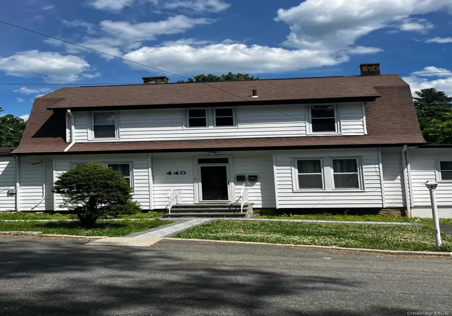 White clapboard siding exterior with a gambrel roof White clapboard siding exterior with a gambrel roof