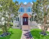 Residence featuring a textured light-colored facade, an arched entry portico, and a dark wood-finish front door with an oval glass insert Residence featuring a textured light-colored facade, an arched entry portico, and a dark wood-finish front door with an oval glass insert
