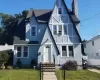 Distinctive Tudor Revival-style residence featuring a prominent front-facing gable and textured stucco siding Distinctive Tudor Revival-style residence featuring a prominent front-facing gable and textured stucco siding
