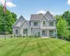 Contemporary gray siding exterior with multiple gables and a covered front porch featuring white columns Contemporary gray siding exterior with multiple gables and a covered front porch featuring white columns