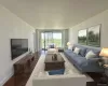 Living area featuring baseboards and wood finished floors Living area featuring baseboards and wood finished floors