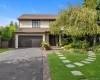 View of front of home with driveway, an attached garage, a front lawn, and roof with shingles View of front of home with driveway, an attached garage, a front lawn, and roof with shingles