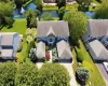 Two-story residence with a gray shingle roof, light blue siding, and white trim Two-story residence with a gray shingle roof, light blue siding, and white trim