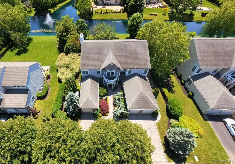 Two-story residence with a gray shingle roof, light blue siding, and white trim Two-story residence with a gray shingle roof, light blue siding, and white trim