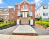 Brick Multi Family home featuring a symmetrical design, dual entry doors, and a stone-paved walkway Brick Multi Family home featuring a symmetrical design, dual entry doors, and a stone-paved walkway
