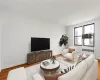 Living area featuring wood finished floors and radiator Living area featuring wood finished floors and radiator