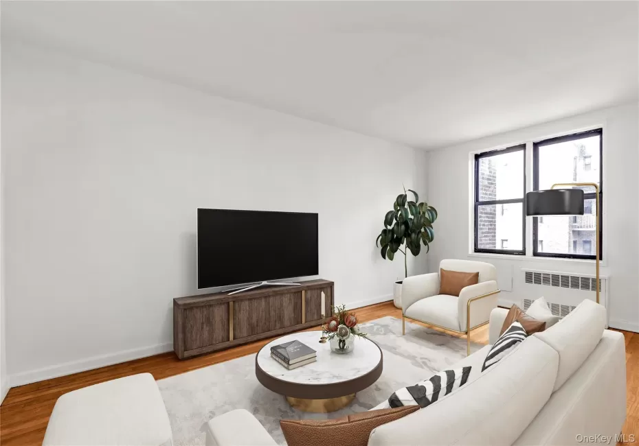 Living area featuring wood finished floors and radiator Living area featuring wood finished floors and radiator