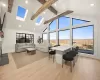 Living area featuring a skylight, light wood flooring, high vaulted ceiling, recessed lighting, and beamed ceiling Living area featuring a skylight, light wood flooring, high vaulted ceiling, recessed lighting, and beamed ceiling
