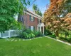 Brick exterior with white columned portico entry Brick exterior with white columned portico entry