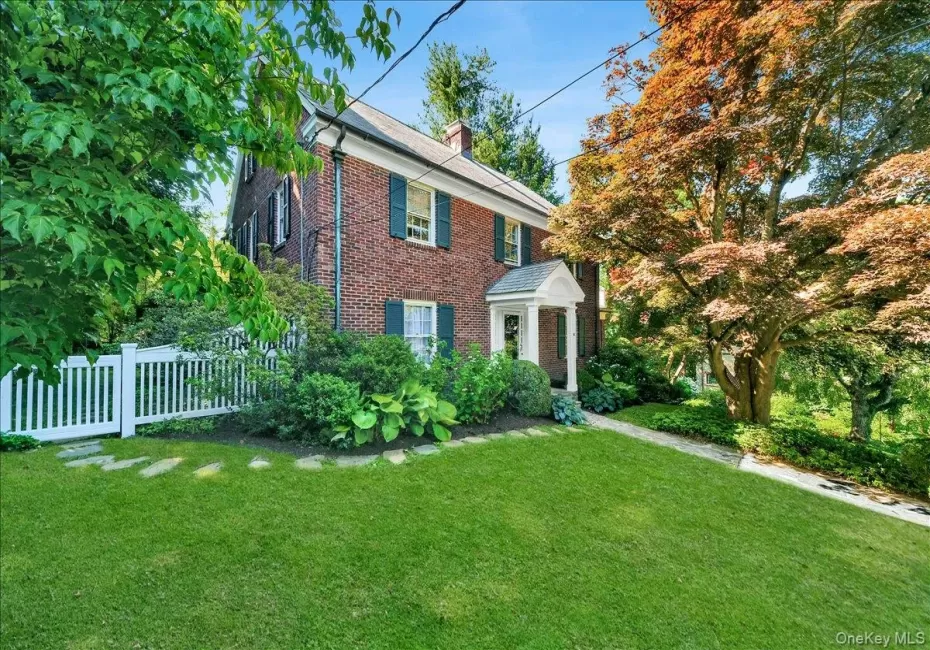Brick exterior with white columned portico entry Brick exterior with white columned portico entry