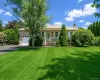 Ranch-style residence featuring a single-car garage, newly paved large driveway, covered front porch Ranch-style residence featuring a single-car garage, newly paved large driveway, covered front porch