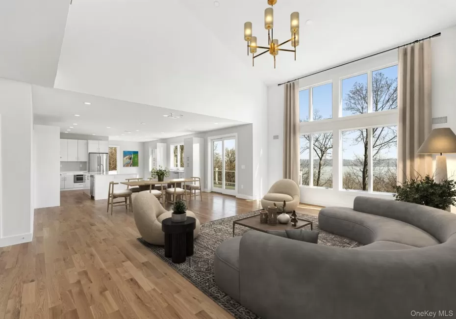 Impressive Great Room open to the Chef's kitchen with deck access virtually staged Impressive Great Room open to the Chef's kitchen with deck access virtually staged