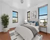 Bedroom with wood finished floors and ornamental molding Bedroom with wood finished floors and ornamental molding