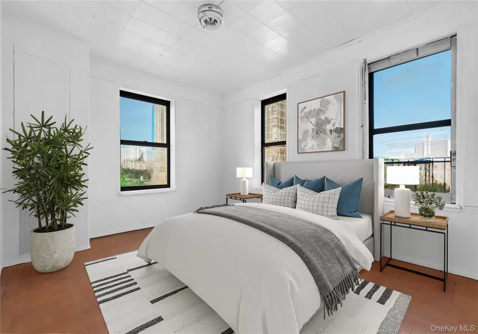 Bedroom with wood finished floors and ornamental molding Bedroom with wood finished floors and ornamental molding