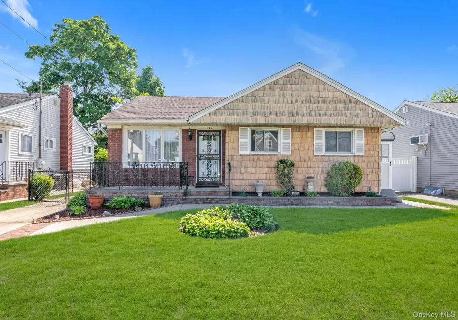 Ranch style residence featuring a brick facade and shake siding Ranch style residence featuring a brick facade and shake siding