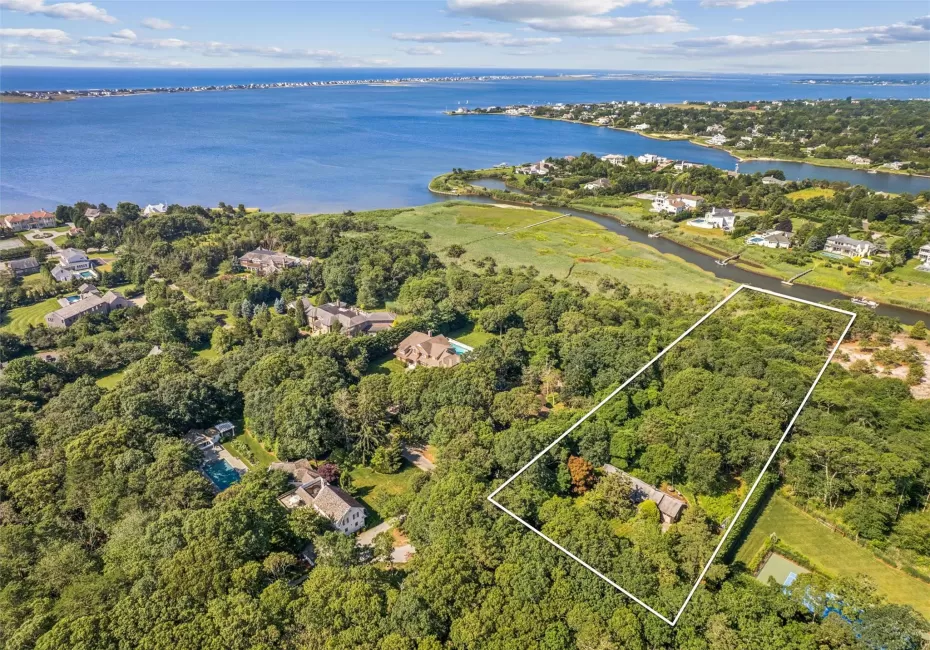 Aerial overview of property's location with a nearby body of water and property boundaries highlighted Aerial overview of property's location with a nearby body of water and property boundaries highlighted