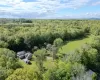 View from above of property featuring a heavily wooded area View from above of property featuring a heavily wooded area