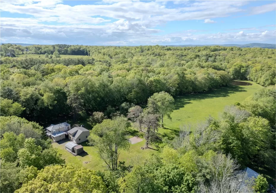 View from above of property featuring a heavily wooded area View from above of property featuring a heavily wooded area
