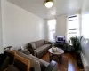 Living area with a baseboard heating unit and hardwood / wood-style floors Living area with a baseboard heating unit and hardwood / wood-style floors