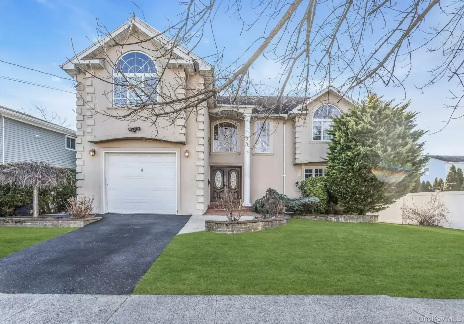 View of front of property with stucco siding, asphalt driveway, and a garage View of front of property with stucco siding, asphalt driveway, and a garage