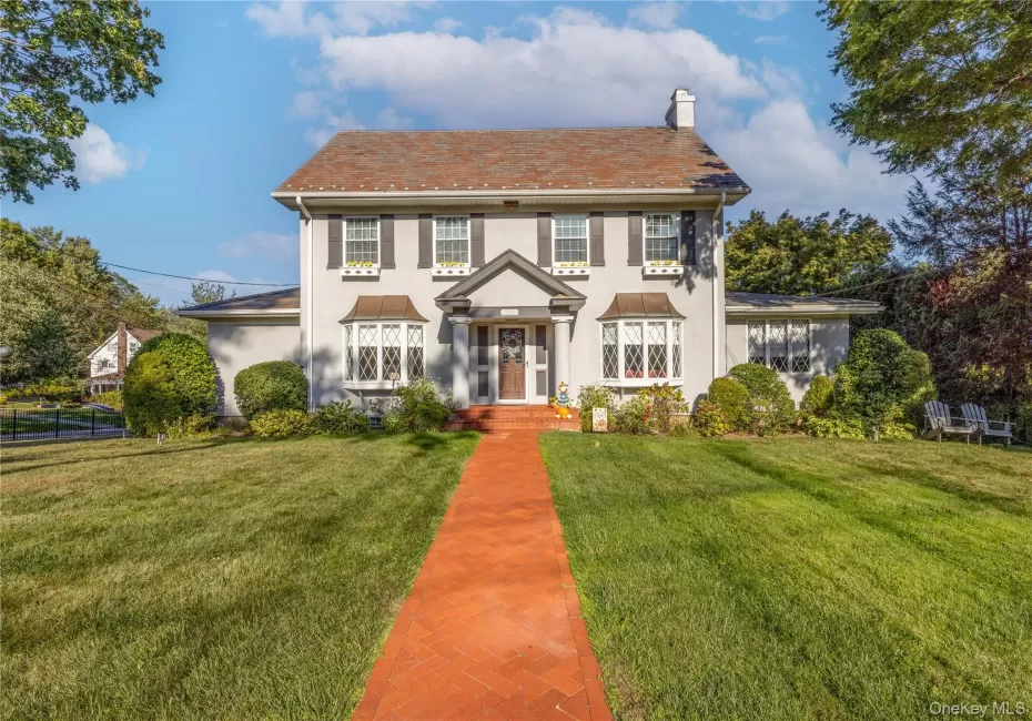 Classic center hall colonial on a large lot with a deep front lawn, herringbone brick walkway and timeless 2 story elegance Classic center hall colonial on a large lot with a deep front lawn, herringbone brick walkway and timeless 2 story elegance