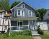 Two-story residence featuring blue siding and white trim Two-story residence featuring blue siding and white trim