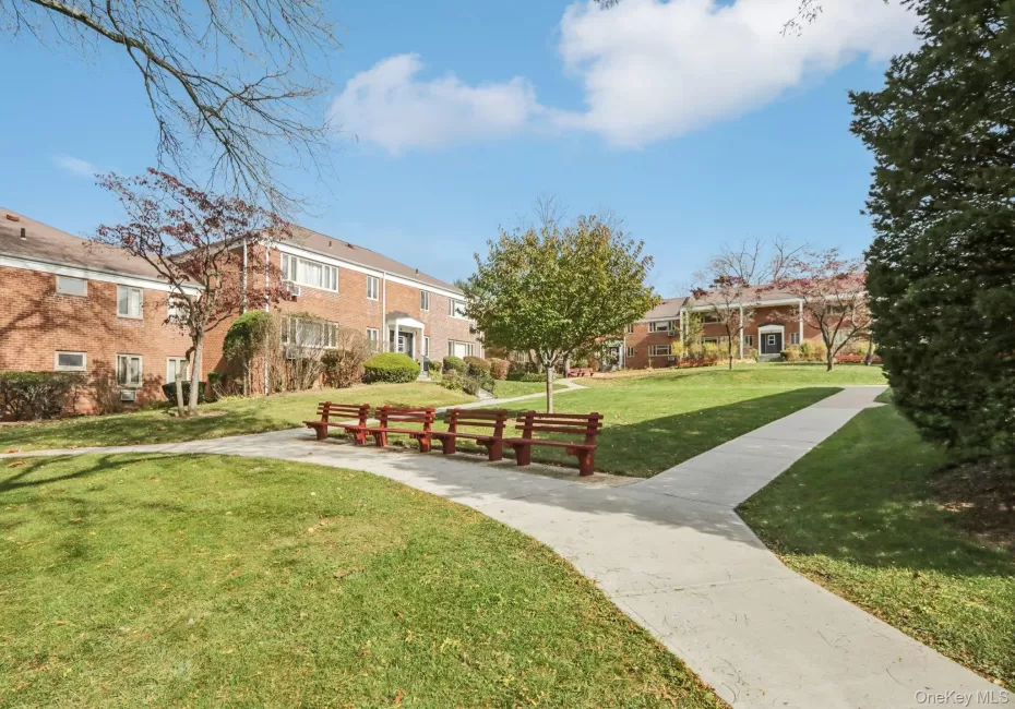View of property's community featuring a lawn View of property's community featuring a lawn