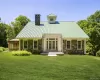 Contemporary architect-designed residence featuring a standing seam metal roof, central cupola, and multi-pane windows Contemporary architect-designed residence featuring a standing seam metal roof, central cupola, and multi-pane windows