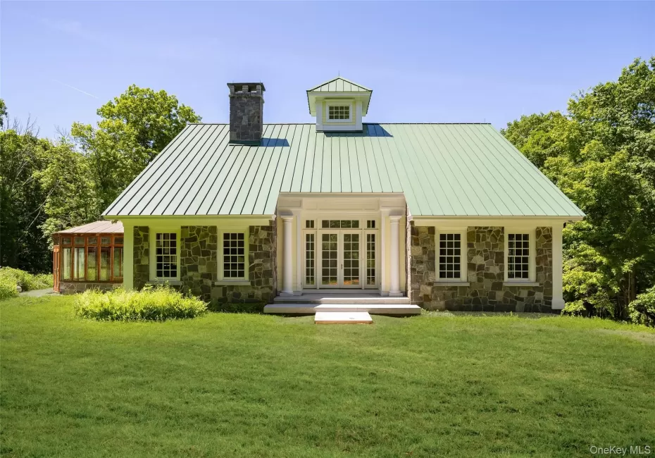 Contemporary architect-designed residence featuring a standing seam metal roof, central cupola, and multi-pane windows Contemporary architect-designed residence featuring a standing seam metal roof, central cupola, and multi-pane windows