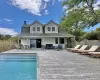 Rear view of property with a deck, a chimney, roof with shingles, and outdoor lounge area Rear view of property with a deck, a chimney, roof with shingles, and outdoor lounge area
