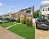 Brick exterior residence featuring a front lawn and paved driveway Brick exterior residence featuring a front lawn and paved driveway
