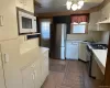 Tiled Kitchen featuring ceiling fan, sink, stainless steel appliances, and a wealth of natural light Tiled Kitchen featuring ceiling fan, sink, stainless steel appliances, and a wealth of natural light