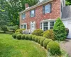 1 Taft - Welcome to Cornwall on Hudson - Brick exterior featuring a white entry door with side lights, multiple bay windows, and dark shutters 1 Taft - Welcome to Cornwall on Hudson - Brick exterior featuring a white entry door with side lights, multiple bay windows, and dark shutters
