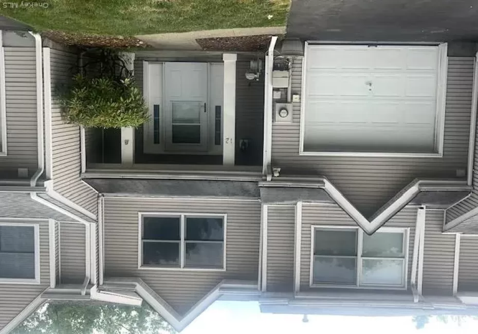 2 story Townhome exterior featuring vinyl siding in a neutral tone 2 story Townhome exterior featuring vinyl siding in a neutral tone