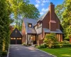 Brick and half-timber exterior featuring a slate roof and copper chimney flashing Brick and half-timber exterior featuring a slate roof and copper chimney flashing