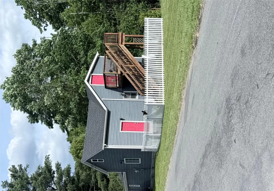 Gray siding exterior with contrasting bright pink doors Gray siding exterior with contrasting bright pink doors