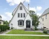 Gable-roof exterior with white stucco finish and contrasting trim Gable-roof exterior with white stucco finish and contrasting trim