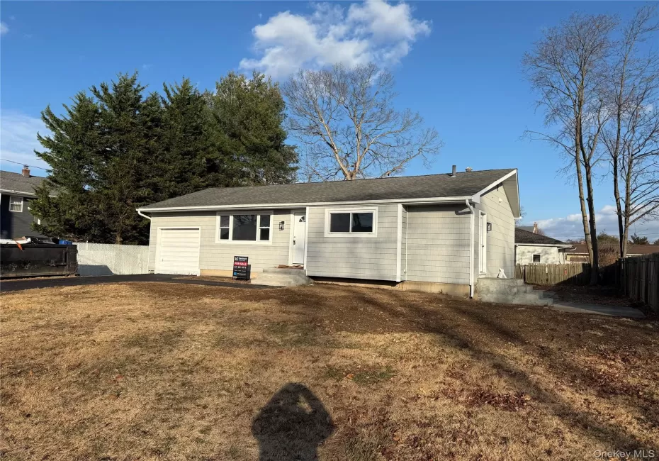Back of property with roof with shingles and a garage Back of property with roof with shingles and a garage