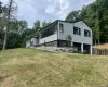 View of side of property featuring a garage and a yard View of side of property featuring a garage and a yard