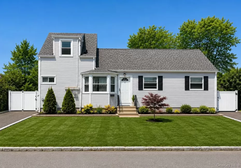 Light-colored siding exterior with a dark-shingled roof Light-colored siding exterior with a dark-shingled roof