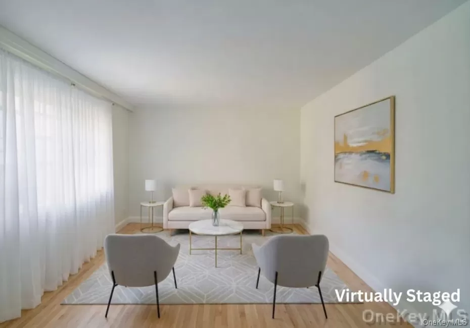 Virtually staged Living room featuring radiator, cooling unit, dark colored carpet, and baseboards. Current status Virtually staged Living room featuring radiator, cooling unit, dark colored carpet, and baseboards. Current status