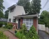 Split-level residence featuring a brick facade and light-colored siding Split-level residence featuring a brick facade and light-colored siding