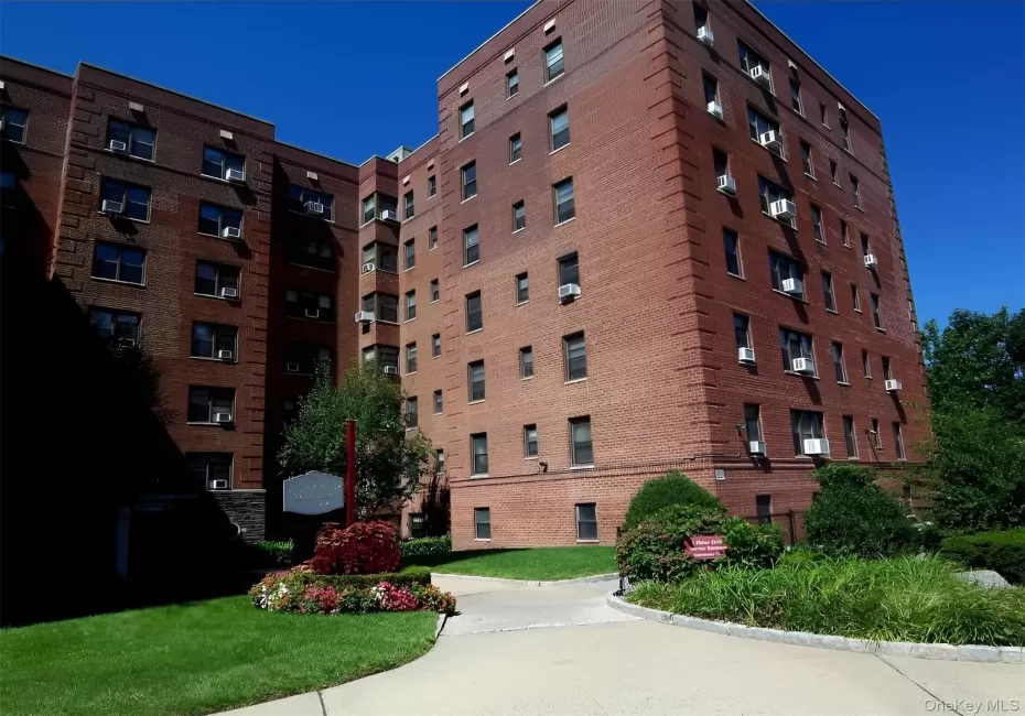 Multi-story brick building featuring architectural detailing and multiple window units Multi-story brick building featuring architectural detailing and multiple window units