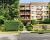 Multi-story residential building featuring a light-colored brick facade. Multi-story residential building featuring a light-colored brick facade.