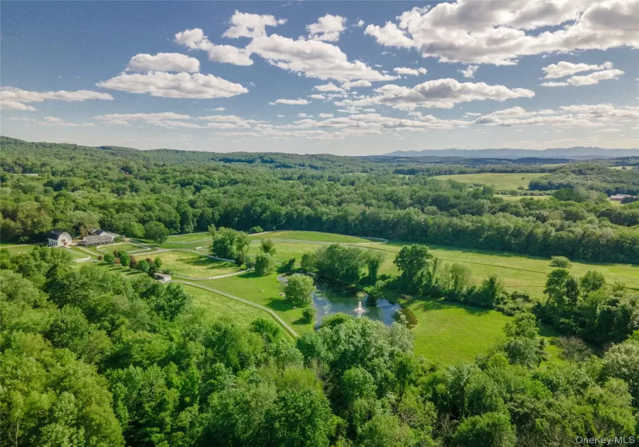 Bird's eye view of a large body of water and a heavily wooded area Bird's eye view of a large body of water and a heavily wooded area
