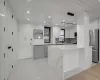 Kitchen featuring stainless steel appliances, tasteful backsplash, light stone counters, white cabinets, and recessed lighting Kitchen featuring stainless steel appliances, tasteful backsplash, light stone counters, white cabinets, and recessed lighting