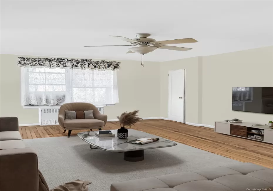 STAGED: Living room with wood finished floors, a ceiling fan, and radiator STAGED: Living room with wood finished floors, a ceiling fan, and radiator