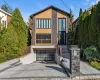 Modern home with decorative driveway, an attached garage, and stone siding Modern home with decorative driveway, an attached garage, and stone siding