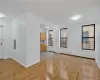 Unfurnished living room with light wood-type flooring, a baseboard radiator, and electric panel Unfurnished living room with light wood-type flooring, a baseboard radiator, and electric panel