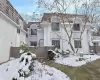 Snow covered house featuring stucco siding and a tiled roof Snow covered house featuring stucco siding and a tiled roof
